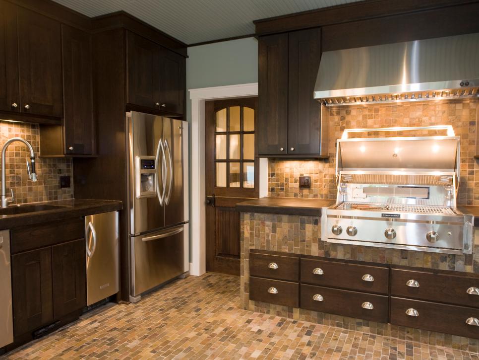 Brown Kitchen With Stainless Appliances and Neutral Tiling
