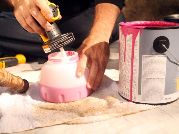 After mixing well, pour porch and deck paint into paint container portion of paint sprayer and attack sprayer head.