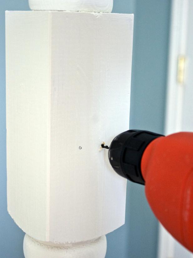 Using a pencil, make marks on the post where each coat hook should be attached. Use a drill bit slightly smaller than the size of the screws included with the coat hooks to pre-drill holes.