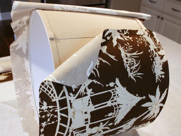Brown Patterned Fabric Being Wrapped Onto Lampshade