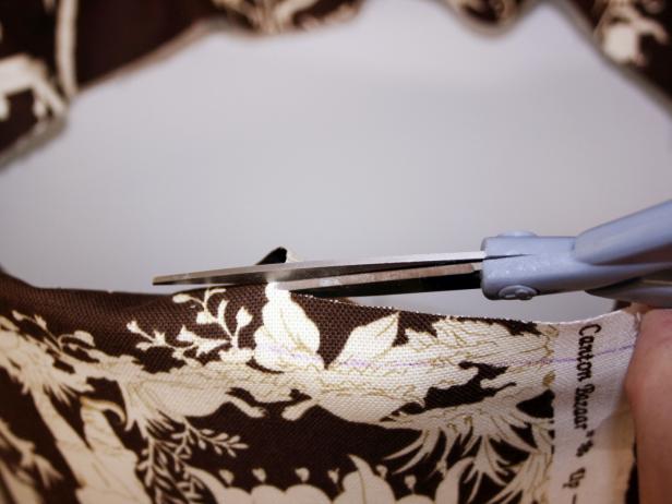 Scissors Cutting Excess Brown Patterned Fabric