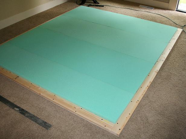 Green Foam Placed on Wood Headboard Frame
