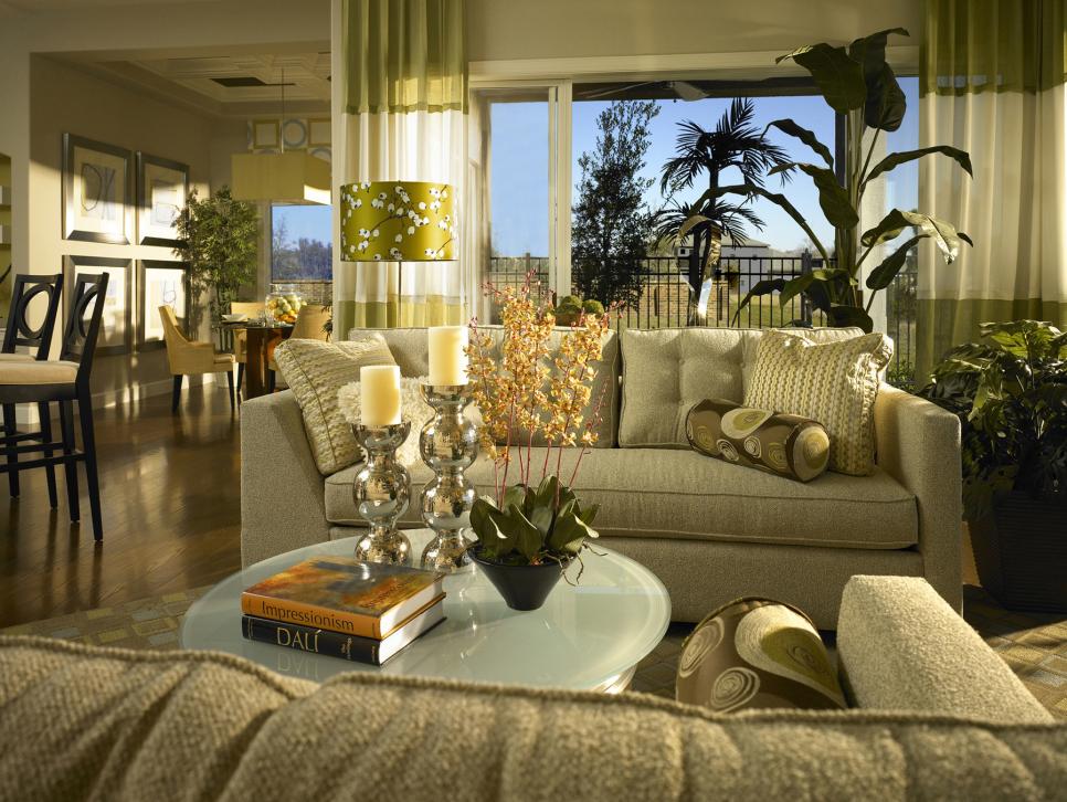 Green Living Room With Various Houseplants and Plush Beige Couches 