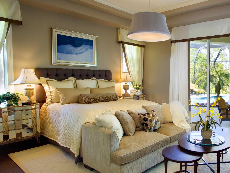 Neutral Bedroom With Drum Pendant, Light-Colored Bedding and Sofa