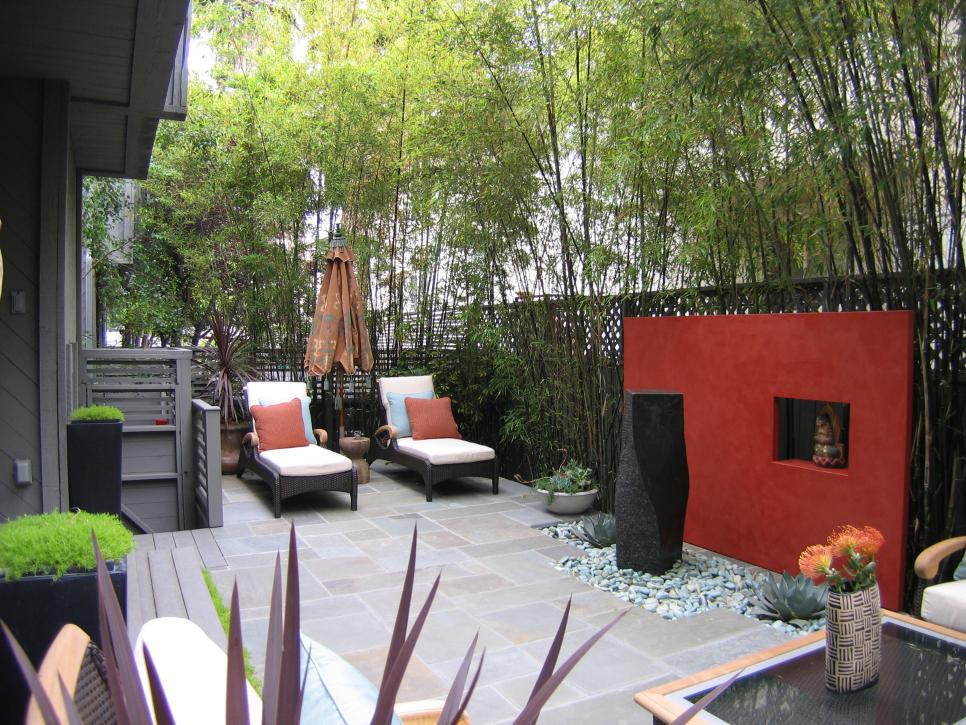 Outdoor Patio With Red Accent Wall, Basalt Fountain and Lounge Chairs