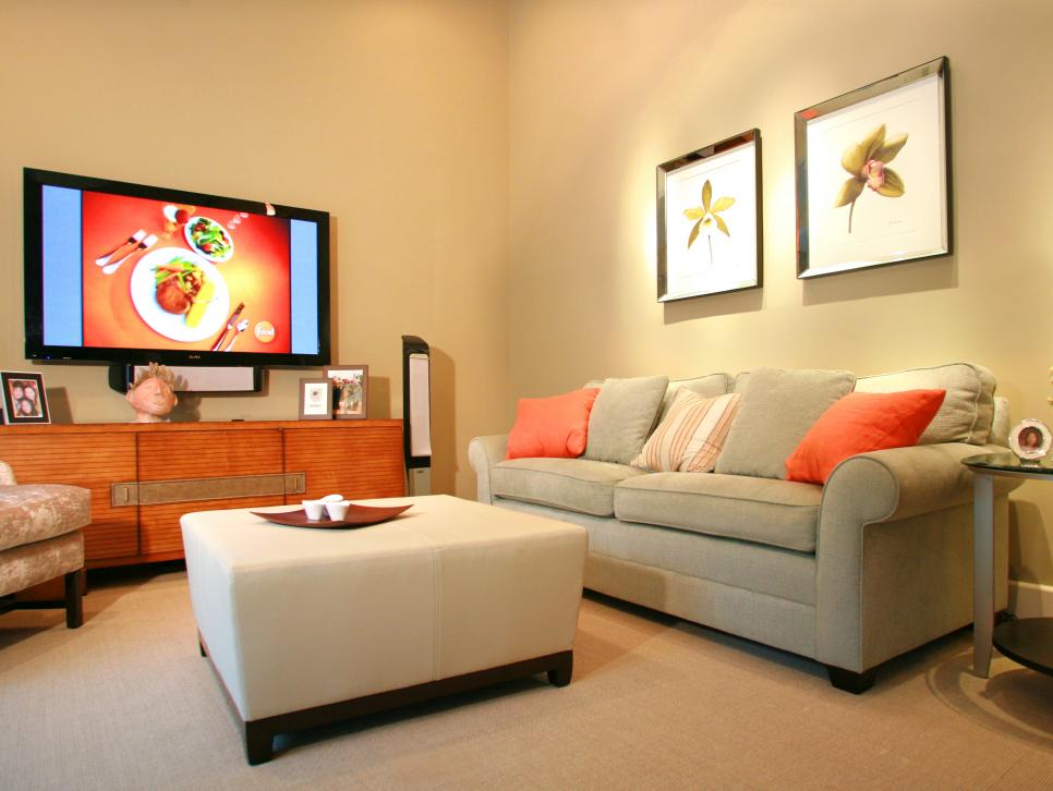 Neutral Family Room With Sofa, Ottoman and Coral Accents