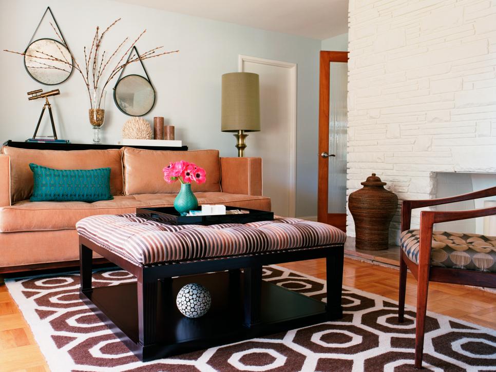 Living Area With Patterned Area Rug and Brown Upholstered Ottoman 