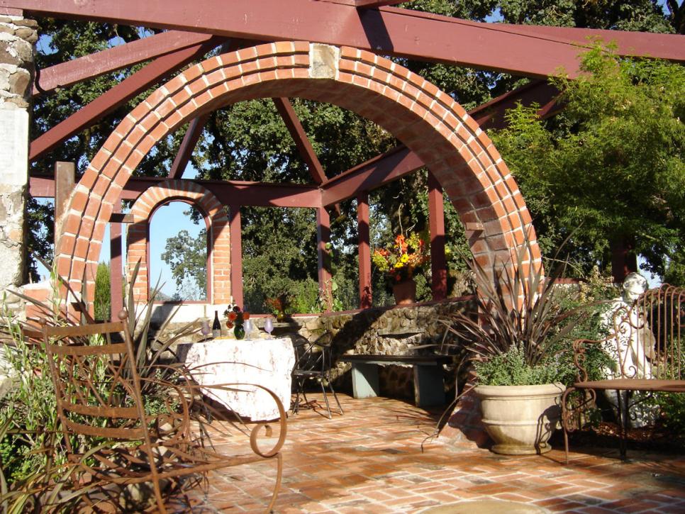 Eclectic Outdoor Space With Brick Pergola
