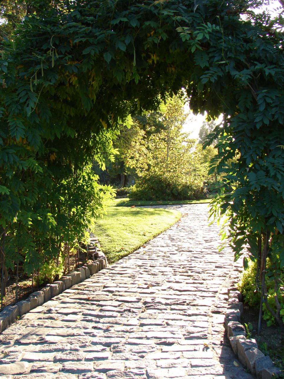 Cobblestone Path Extends Past an Archway