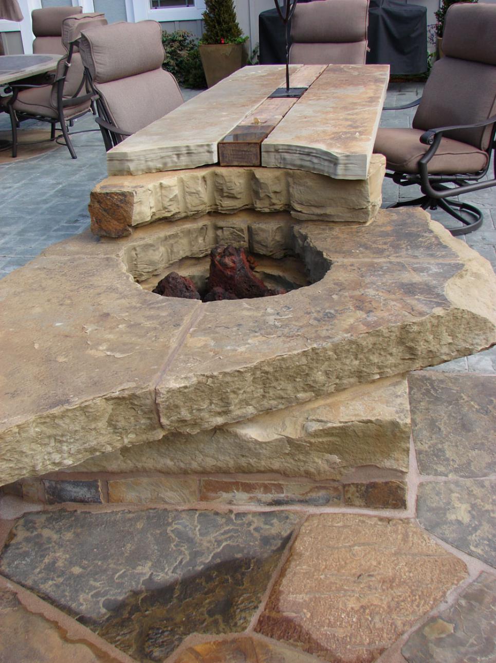 Stone Fire Pit and Table Surrounded By Chairs