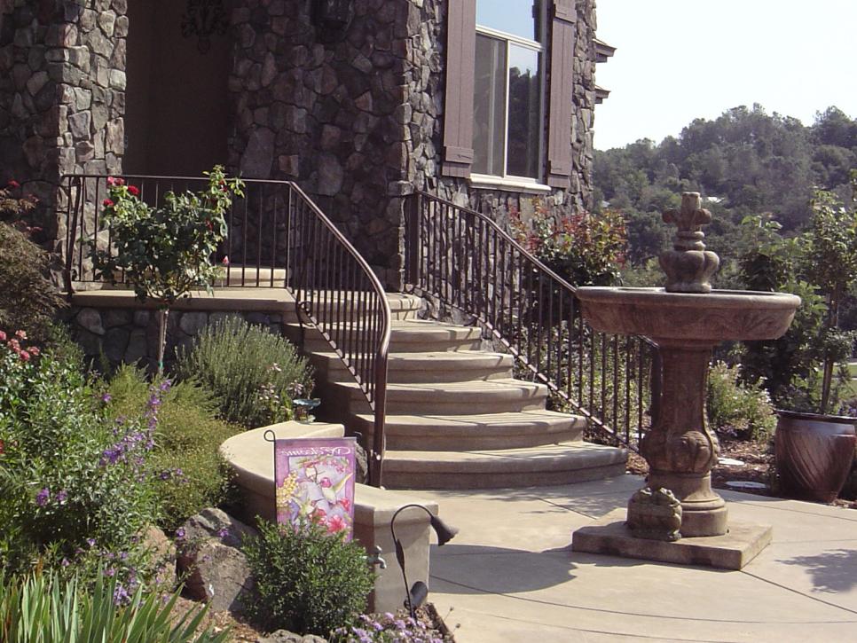 Home Exterior With Water Fountain and Stairs to Porch