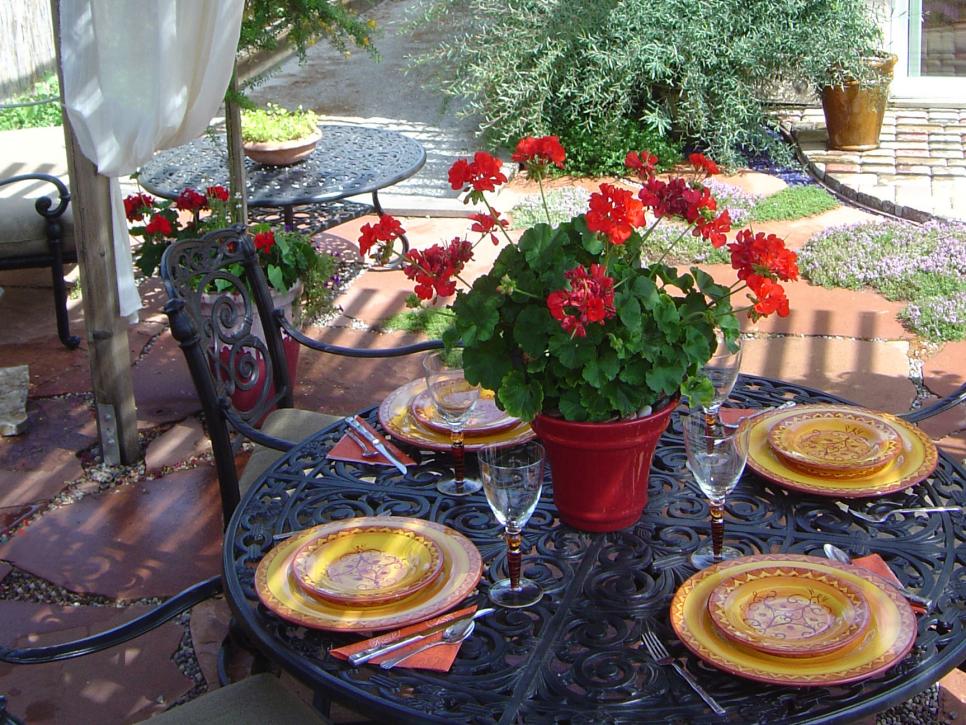 Mediterranean Outdoor Dining Area With Red and Orange Accents