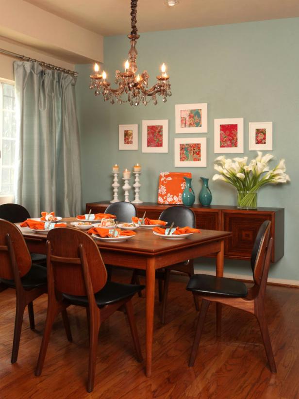 Hues directly opposite each other on the color wheel are complementary colors. For example: green paired with red or orange paired with blue, like this pale blue dining room accompanied by bold orange accents. As the strongest contrasts, complements tend to intensify each other.