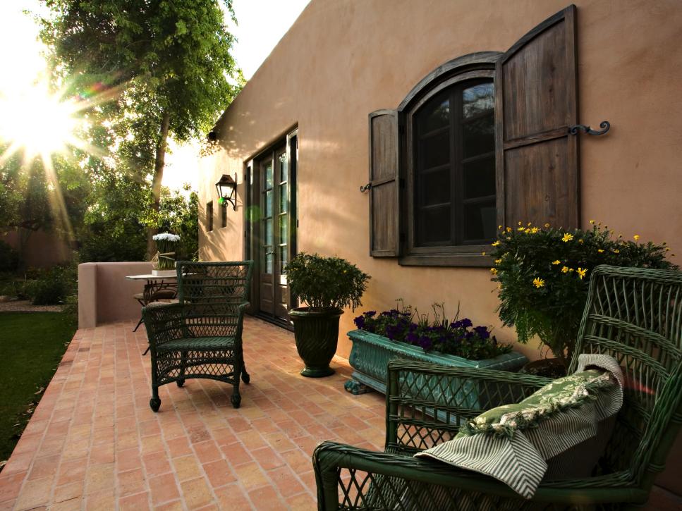 Southwestern Brick Patio With Green Wicker Chairs   