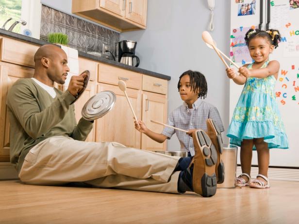 Family Plays in Kitchen With Pots and Pans Family Plays in Kitchen With Pots and Pans
