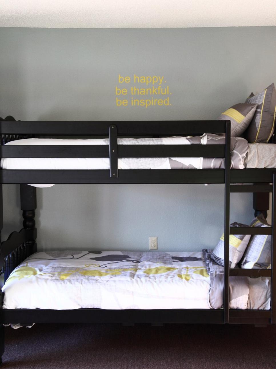 Black Bunk Beds with White and Gray Comforter 