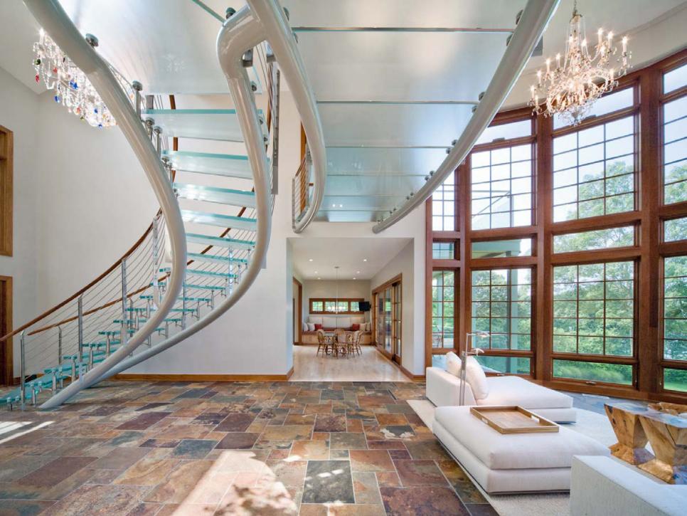 Winding Glass Staircase & Suspended Walkway Above Stone Floor