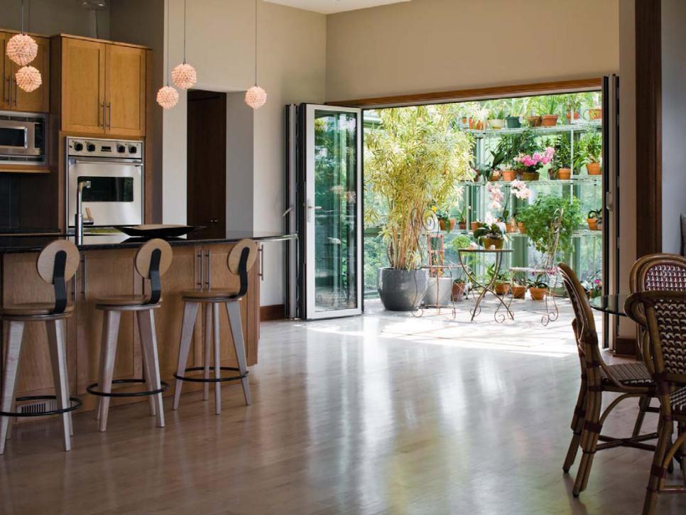 Modern Kitchen Opens to a Greenhouse Room
