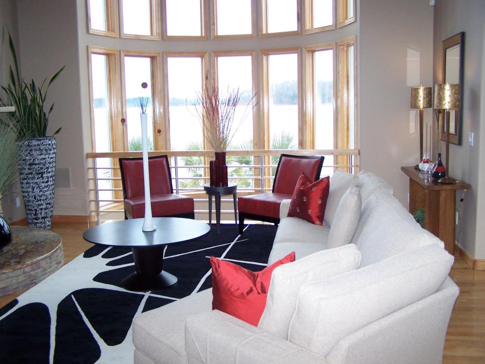 Neutral Living Room With Black and White Rug and Red Chairs