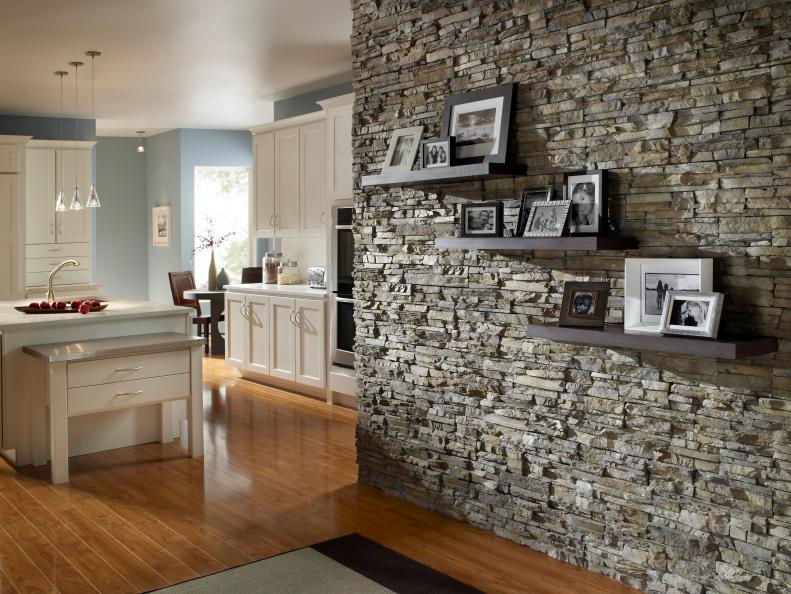 Transitional Kitchen With White Cabinets and Gray Stone Wall