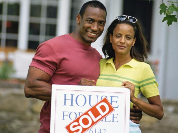Homeowners with Sold Sign Homeowners with Sold Sign