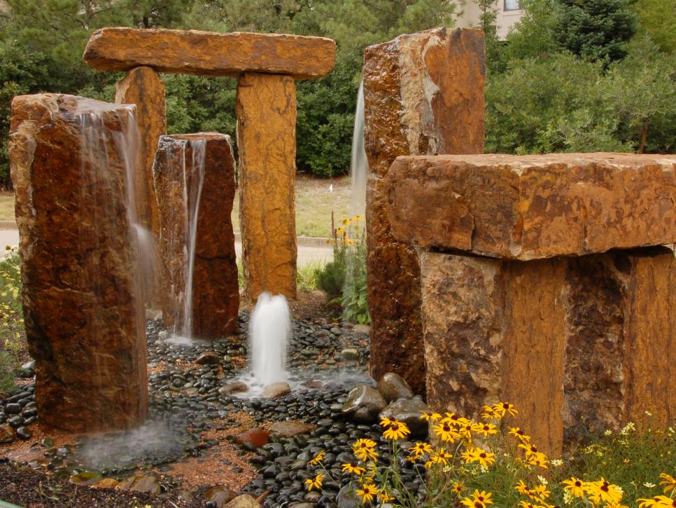 Stonehenge Water Feature With Pebbles and Flowers 