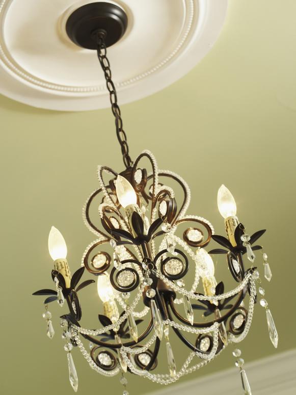 Iron Chandelier with Cream Colored Ceiling Medallion Iron Chandelier with Cream Colored Ceiling Medallion