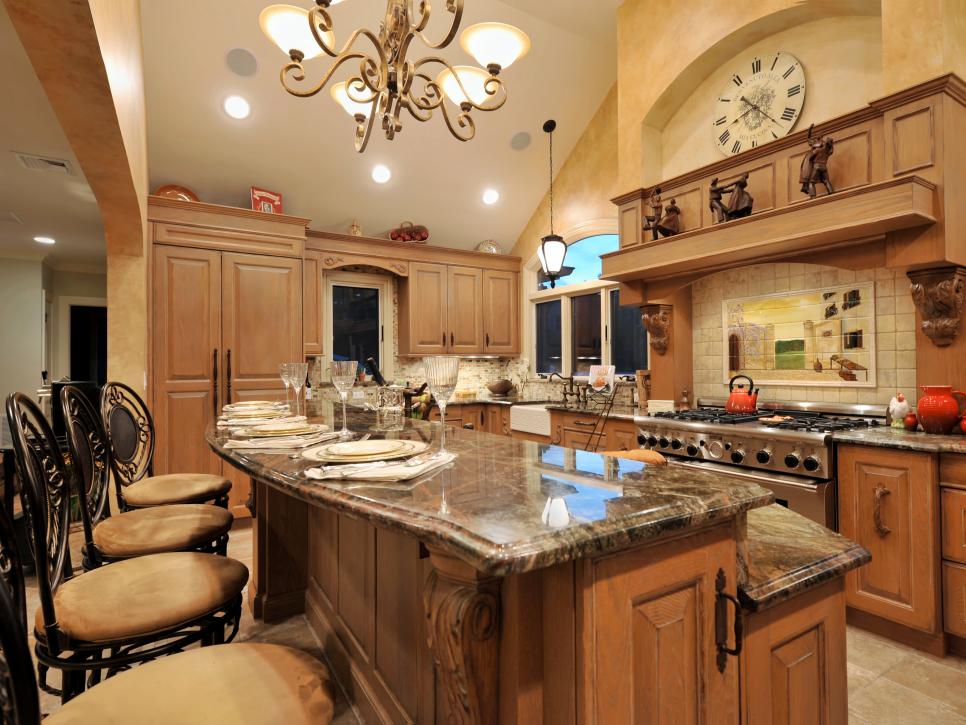 Mediterranean Kitchen With Two-Tiered Granite Island and Bar Seating