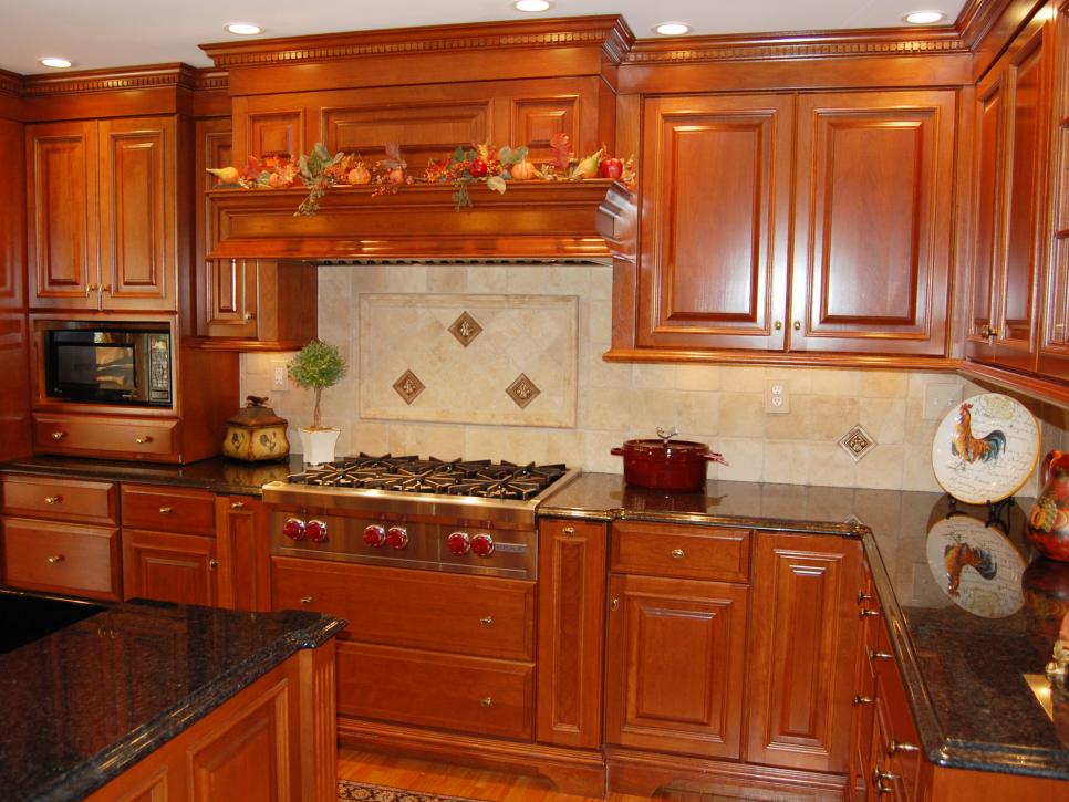 Traditional Kitchen With Wood Cabinetry and Black Granite Countertops