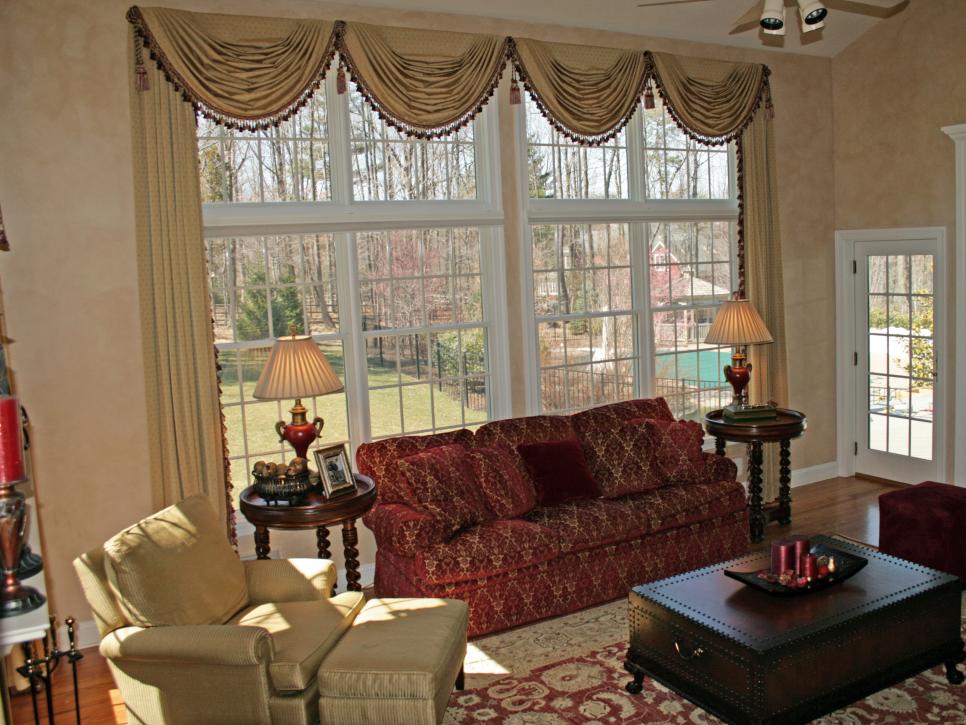 Neutral Living Room With Scalloped Valance and Red Sofa