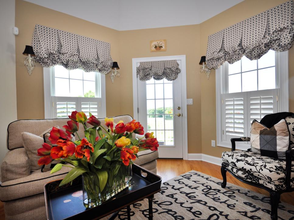 Neutral Living Room With Playful Area Rug and Valances