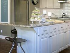 Beige Kitchen With Island, White Cabinets and Granite Counters