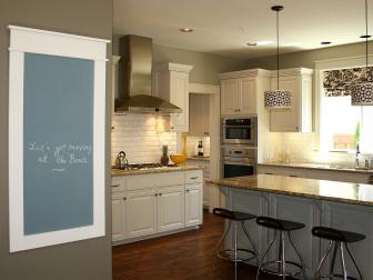 White Kitchen With Framed Chalkboard and Large Island