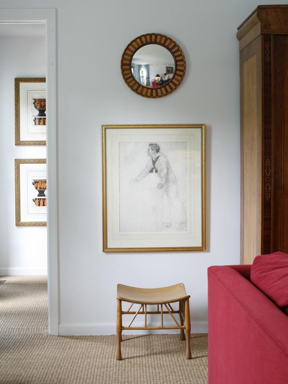 Framed Artwork and Round Decorative Mirror on White Wall