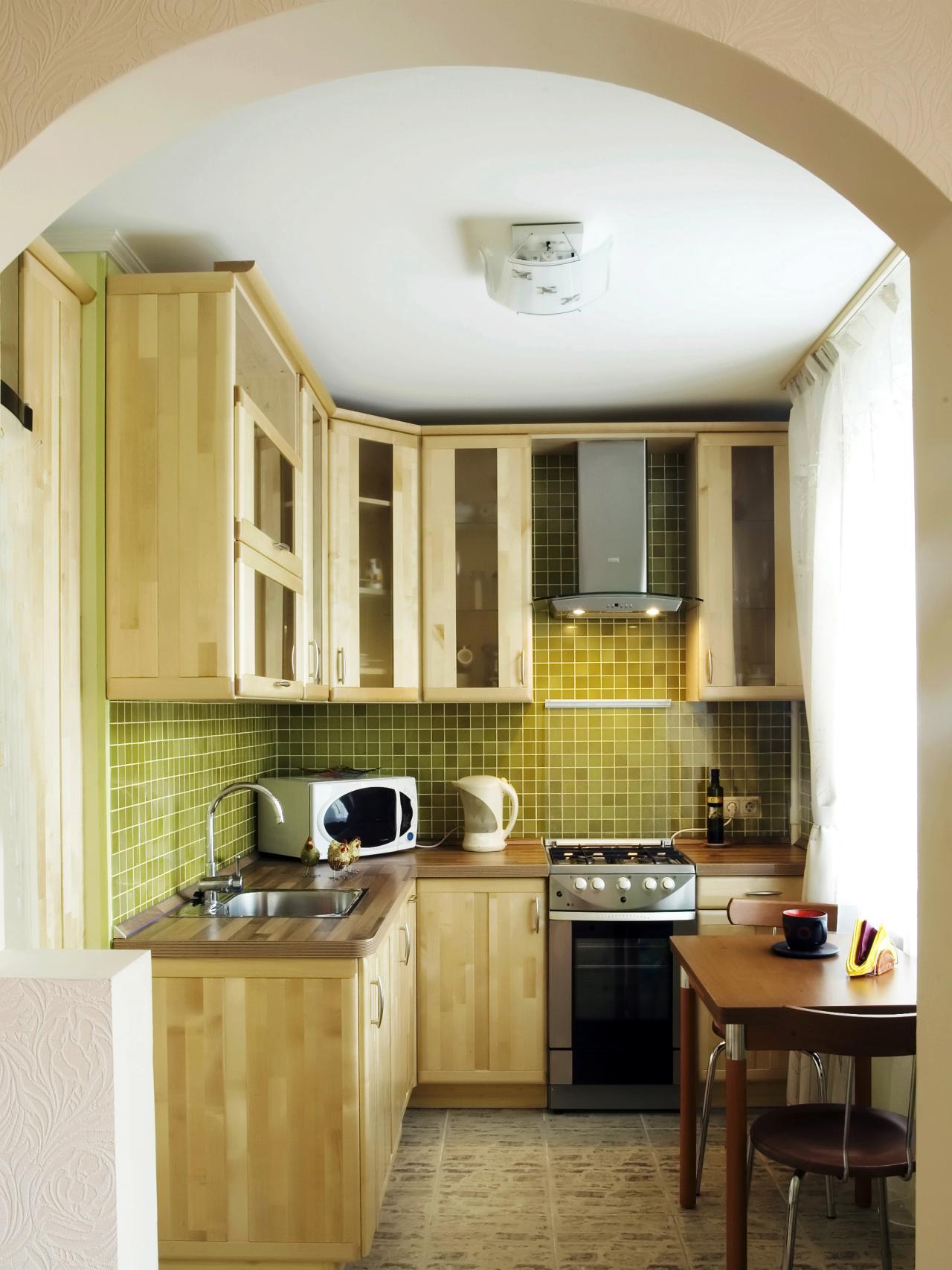 downsized appliances light wood cabinetry and a large open window