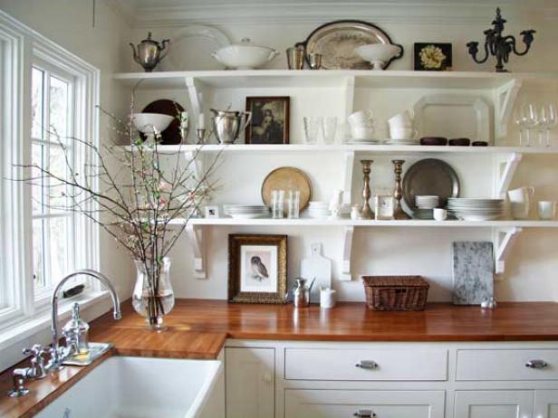 If your kitchen is short on cupboards or if you just want to make it seem more spacious, opt for open shelving. You can show off your favorite dishes while keeping your kitchen feeling open, airy and a little less small. Image courtesy of A Country Farmhouse.