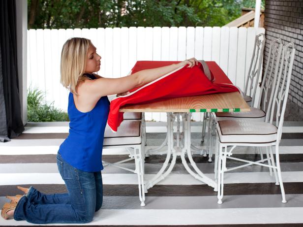 Place tablecloth atop plywood, ensuring drop edges conceal all four sides.