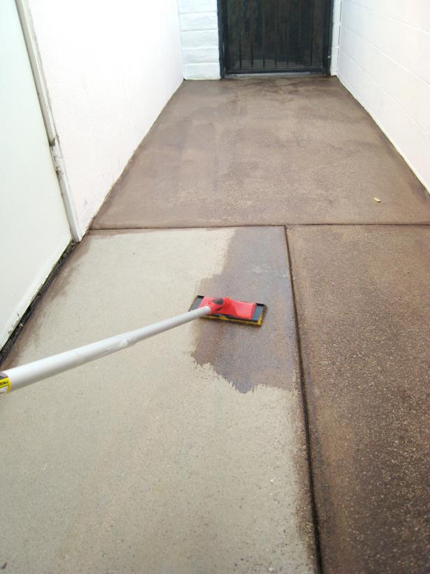 Begin applying the stain over the rest of the concrete with the pad. Use the seams as natural divisions to work in. Stay in only one section at a time so you can maintain control over blending without it drying too quickly.