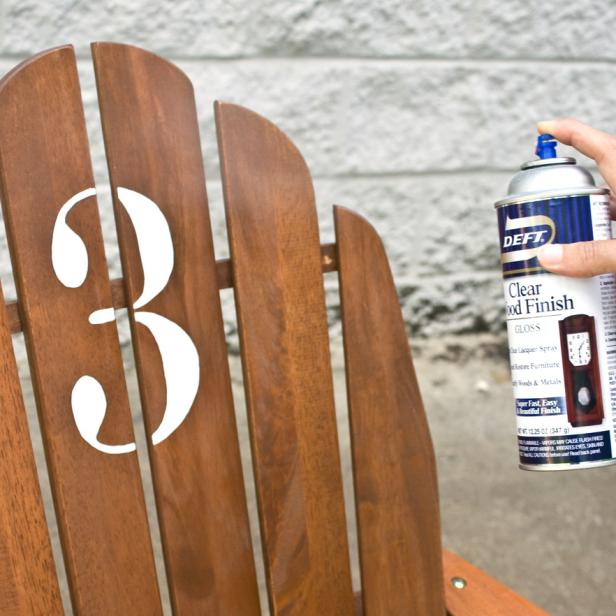 Clear Wood Finish on Stenciled Chair Applying Clear Wood Sealer on Painted Number Three on Back of Chair