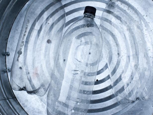Fill trash can approximately 3/4 full, using empty 2-liter bottles.