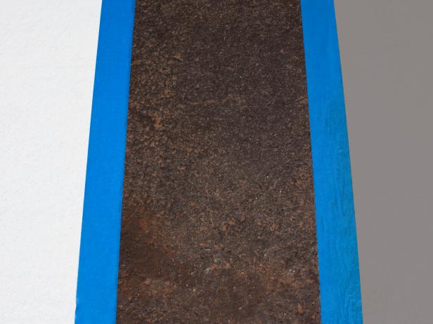 Move tape to cover new stripe for clean lines.