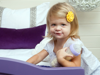 Girl in bedroom with purple bed