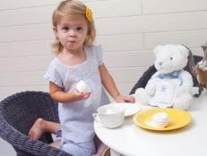 Little Girl Haing a Tea Party with Her Stuffed Bear 