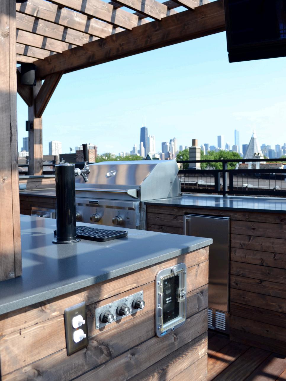 Urban Outdoor Kitchen With Stainless Steel Counters and Grill