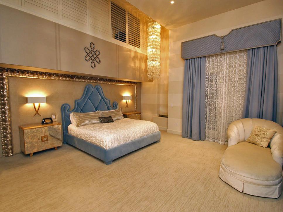 Blue Velvet Bed in Romantic Open Bedroom With High Crystal Chandelier