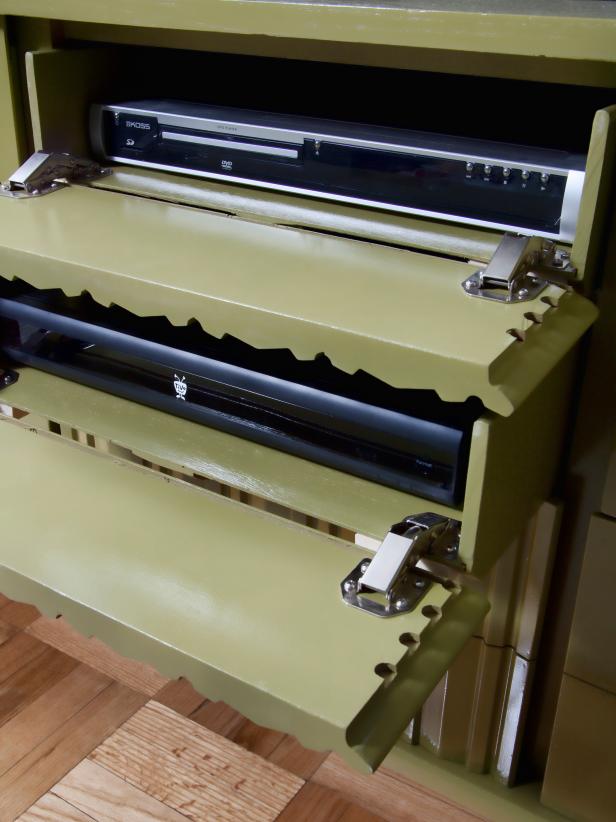 To transform a dresser into a concealed media console, the interiors of drawers need to be outfitted with hinges that allow the door fronts to flip open, giving access to media components and remote controls.