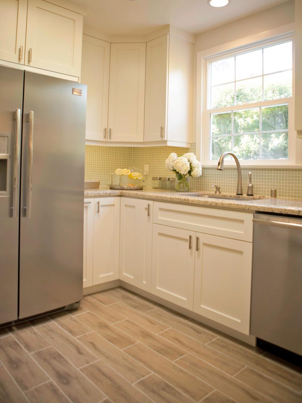 White Kitchen With Glass Tile Backsplash and Stainless Appliances