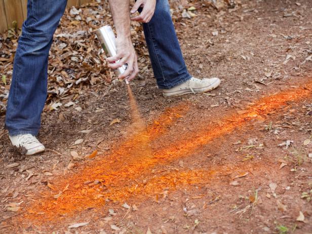 Spray Painting Ground With Orange Arrow Spray Painting Ground With Orange Arrow