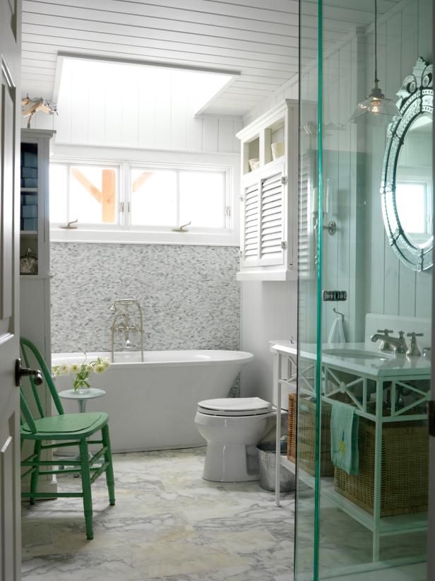 White Bathroom with Wood Paneled Walls and Slipper Tub