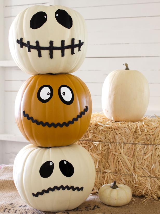 Stacked Faux Pumpkins With Felt Faces on Front Porch
